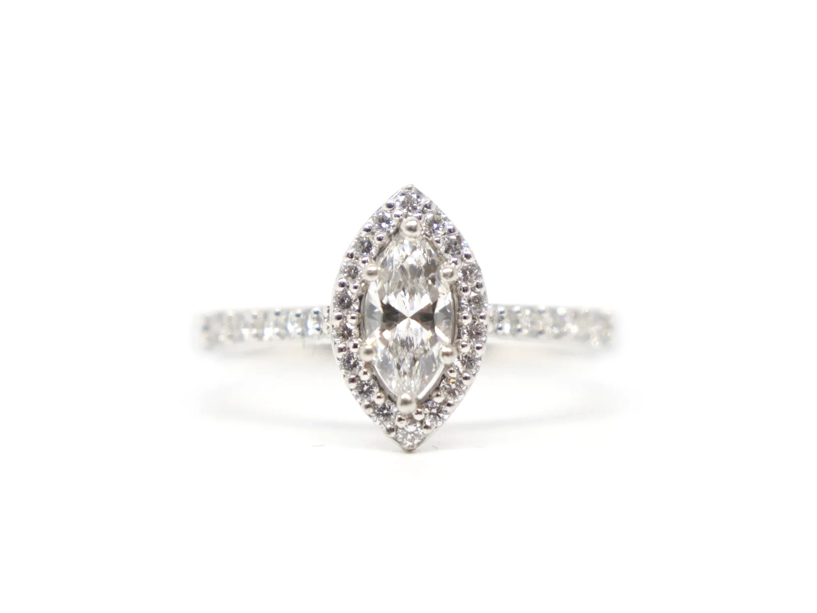 platinum diamond halo ring set with a marquise-cut diamond at the centre, surrounded by a pavé-set halo