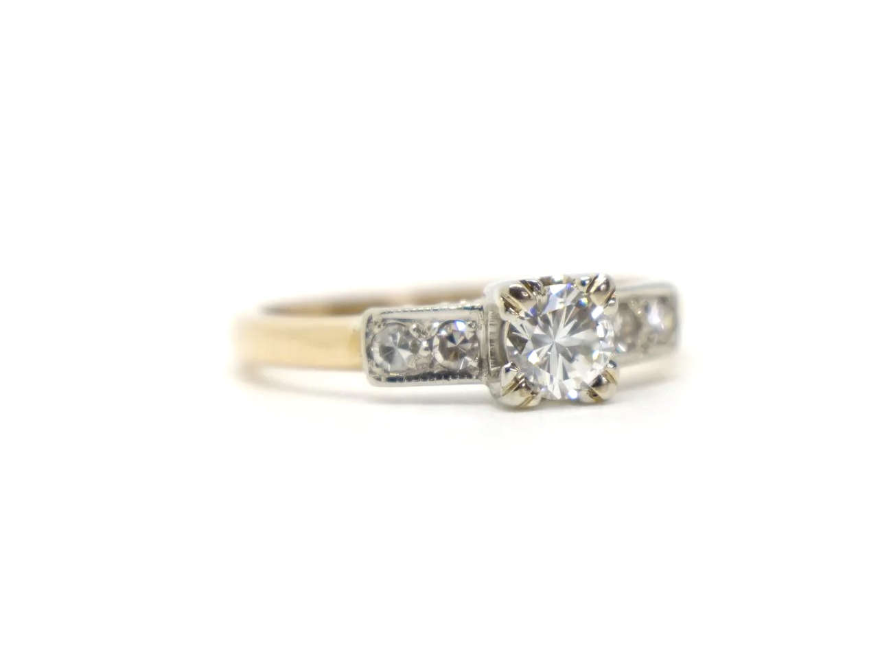 Stunning vintage 18ct gold diamond solitaire ring, set with a central brilliant cut diamond and with further small diamonds to each shoulder.