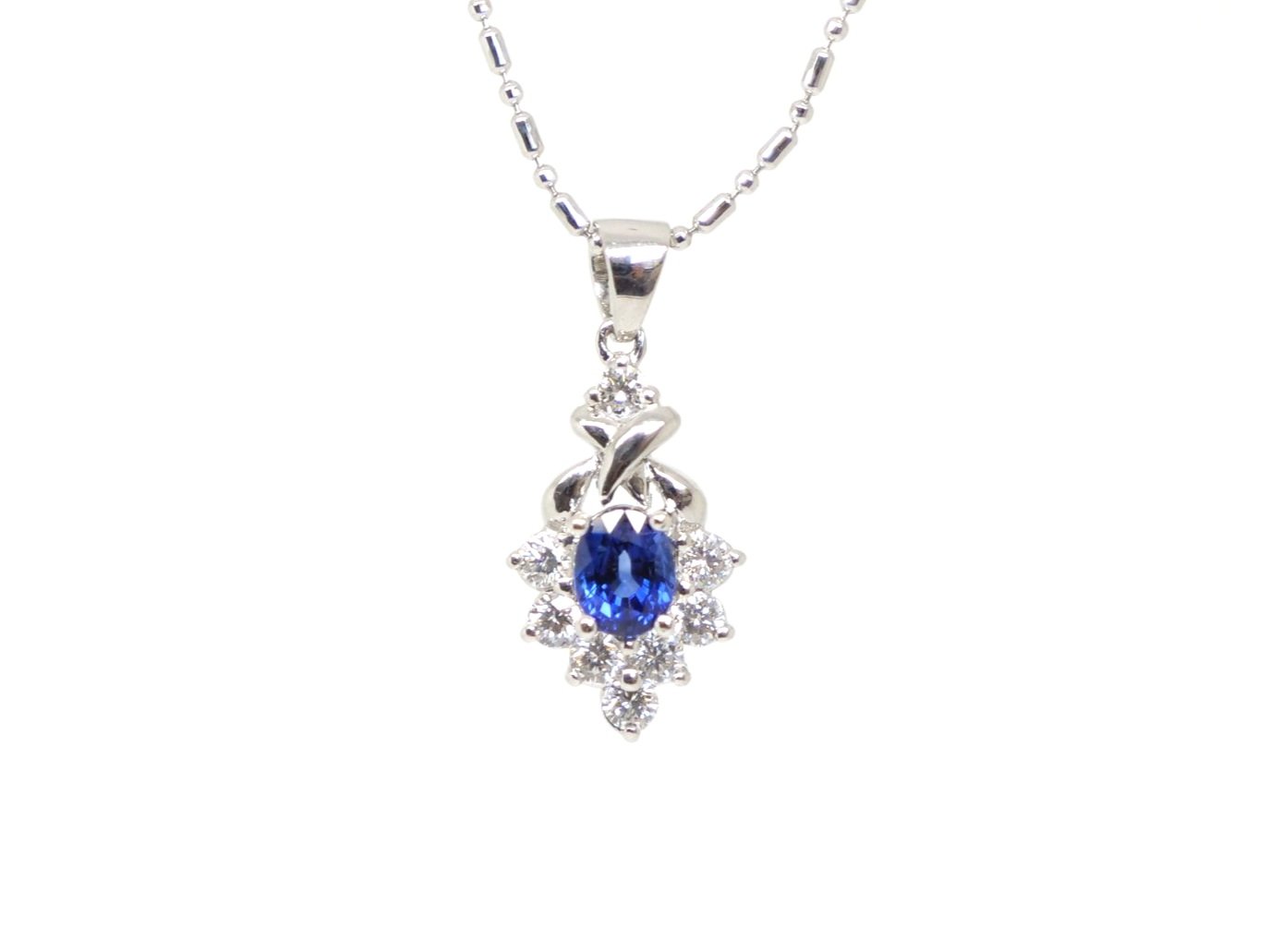 Very elegant 18ct gold sapphire and diamond pendant and chain, set with an oval cut sapphire and surrounded by diamonds.