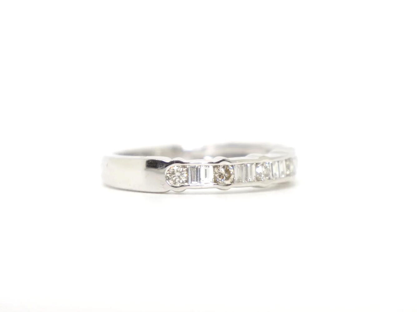 18ct white gold half eternity ring with alternating round and baguette cut diamonds