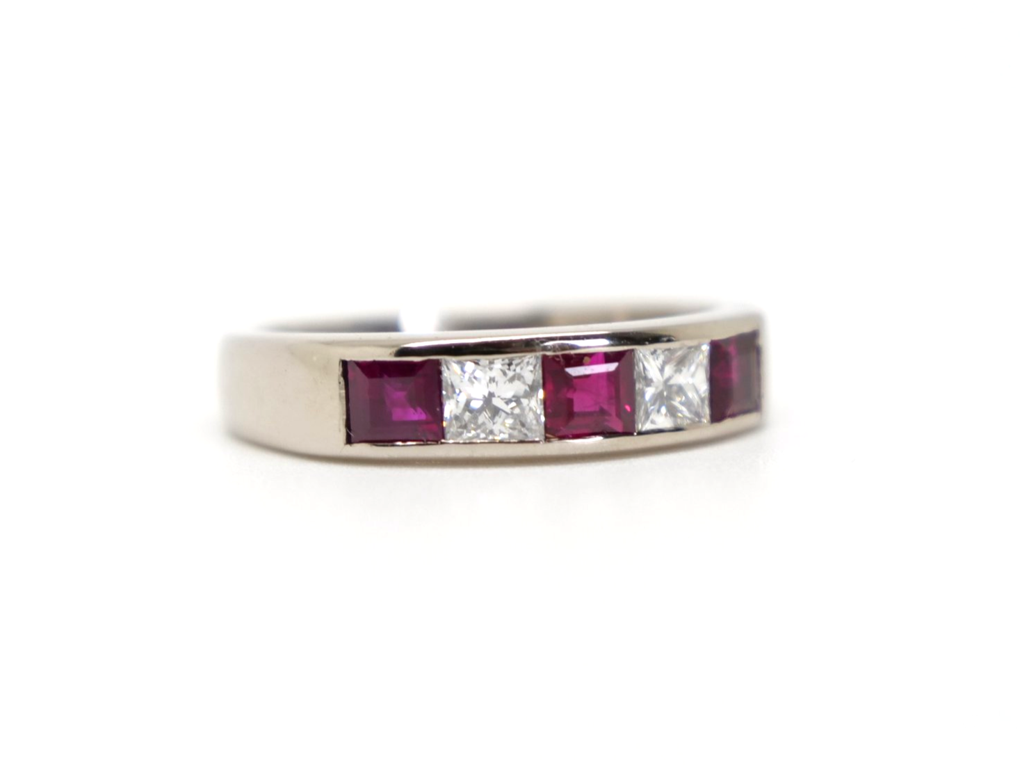 Bespoke 18ct gold ruby and diamond half eternity style ring, set with step cut rubies and princess cut diamonds.