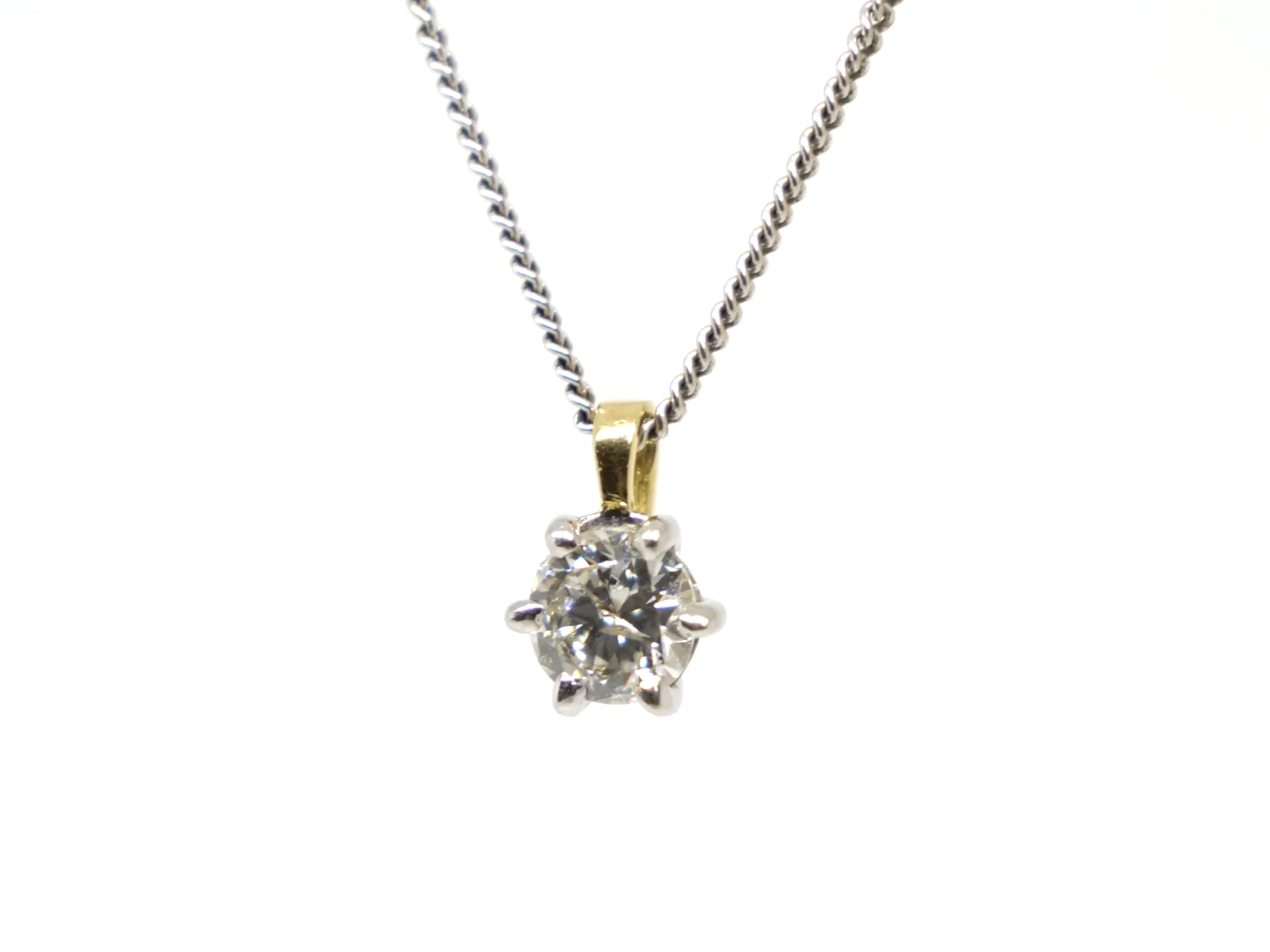 Classic 18ct gold diamond solitaire pendant, set with a very sparkly brilliant cut diamond. Diamond set in white gold with yellow gold bale.
