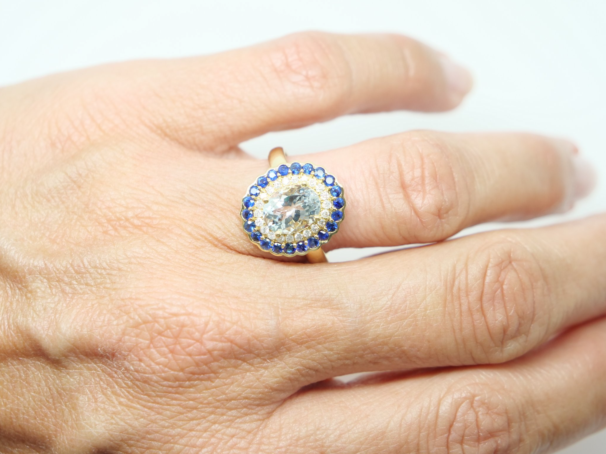 Very unusual 18ct gold aquamarine, diamond and sapphire cluster ring, set with a large central aquamarine and surrounded by diamonds and then sapphires.