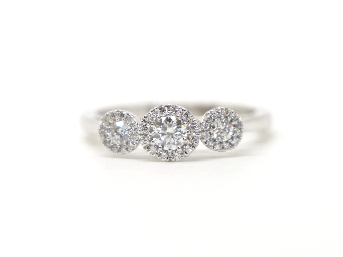 Contemporary 18ct gold diamond ring in a very pretty triple halo three stone design. Approximately 0.5cts diamonds total.