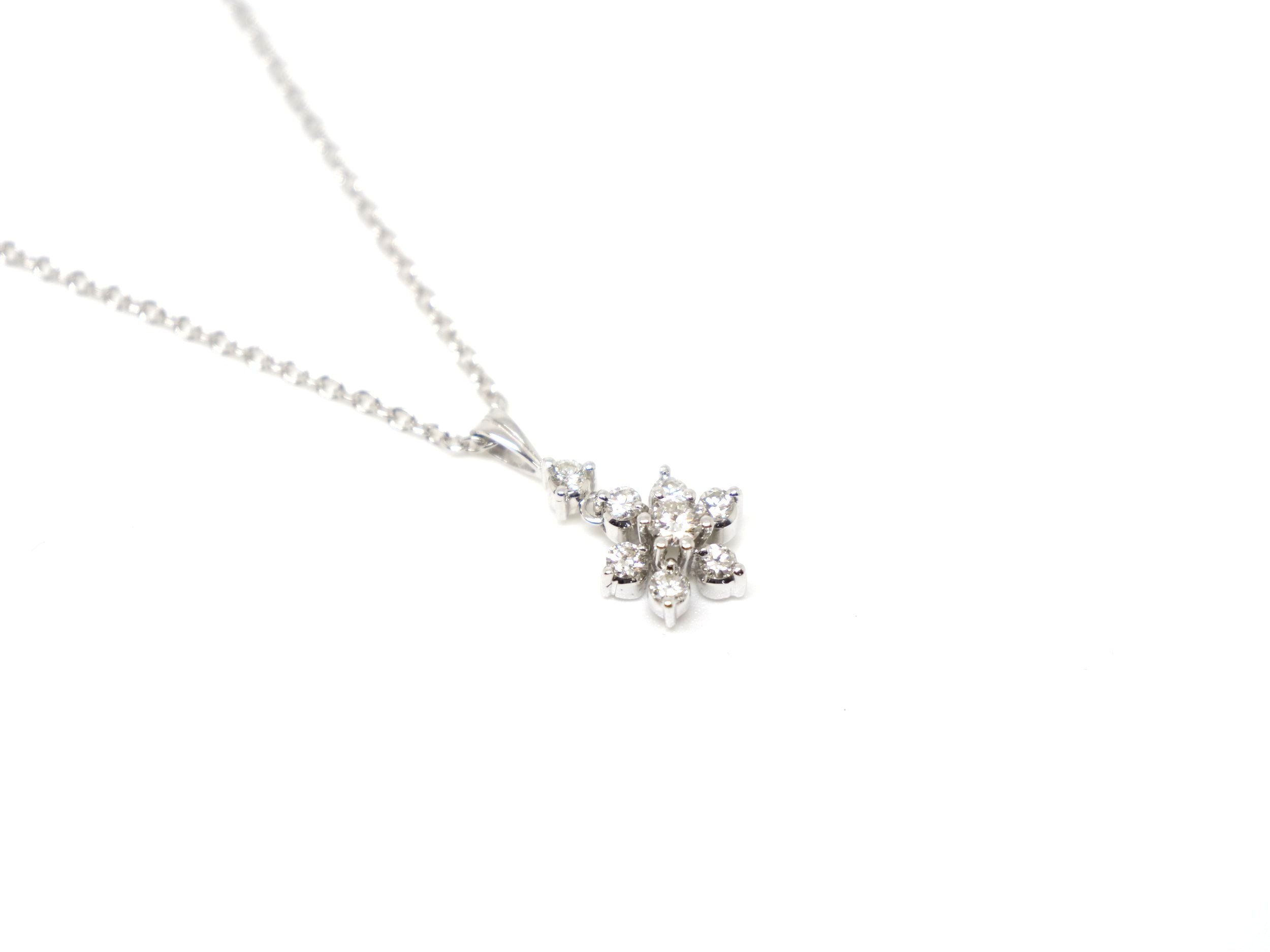 Very elegant 9ct gold diamond flower pendant and chain, set with a small drop diamond and then a lovely diamond flower. Approximately 0.5ct diamonds total.