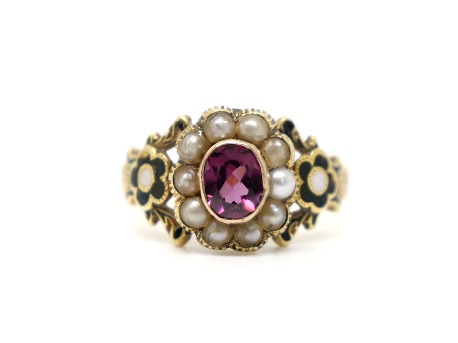 Lovely 18ct gold Georgian garnet and seed pearl ring, set with an oval cut garnet and surrounded by seed pearls. Black enamel flower design to each shoulder.