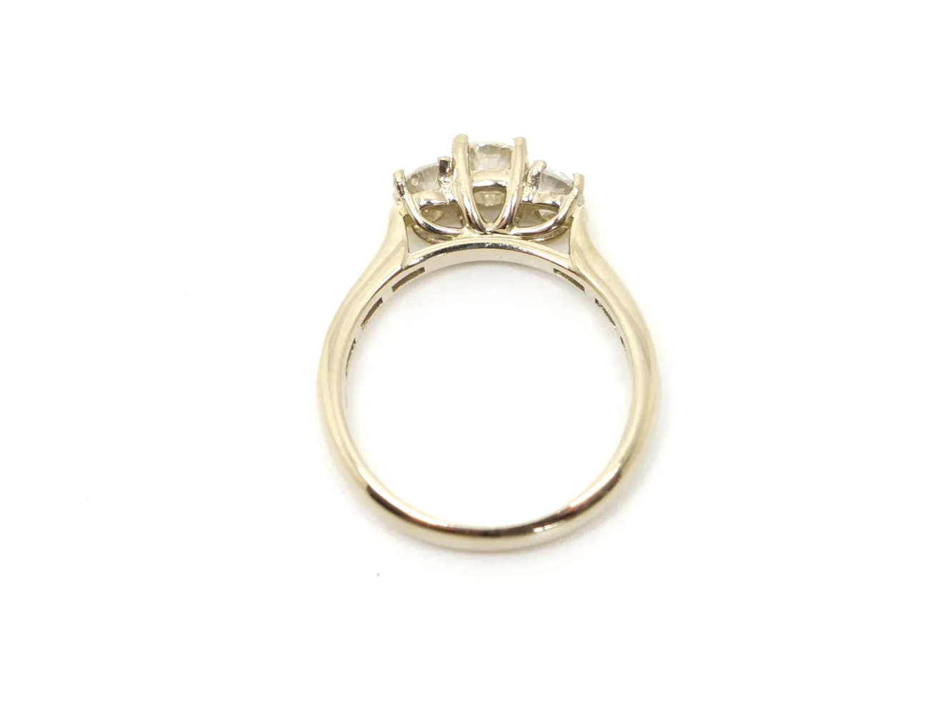 Very pretty 18ct gold diamond three stone ring, set with three brilliant cut diamonds, with further diamonds set into each shoulder. Total diamond weight approximately 1ct.