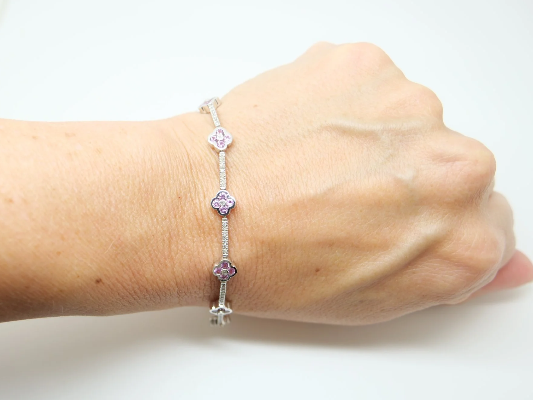 Very pretty 9ct gold pink sapphire and diamond bracelet, set with pink sapphire flowers with diamond links between.
