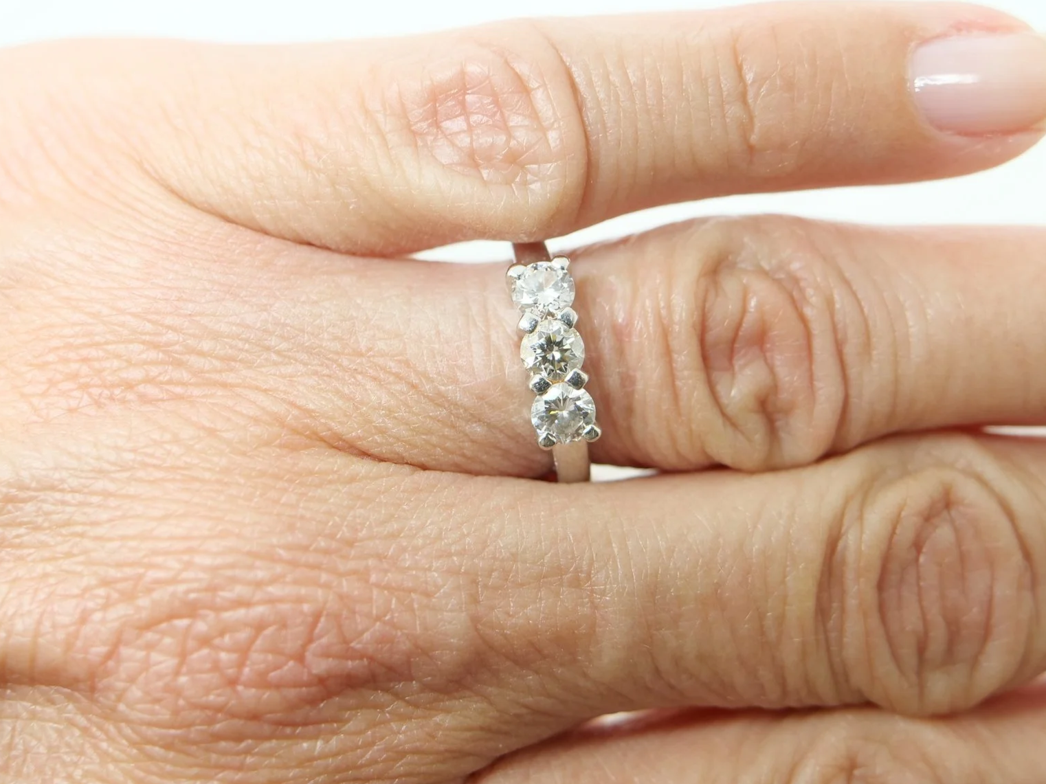 Platinum three stone 1ct diamond ring, three round brilliant cut diamonds in claw settings, hallmarked 2005, UK size K½