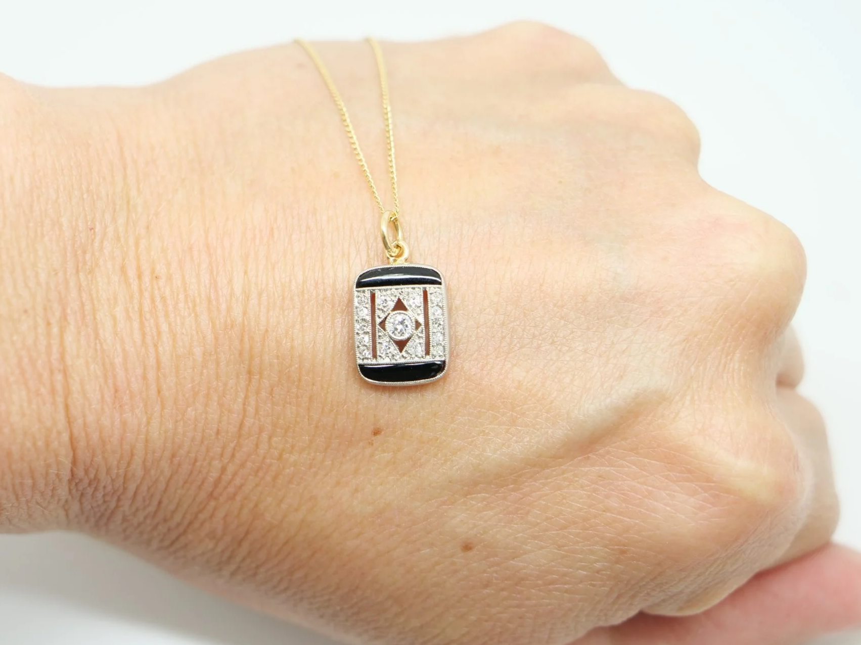 Art Deco onyx and diamond pendant, set in platinum and 18ct gold
