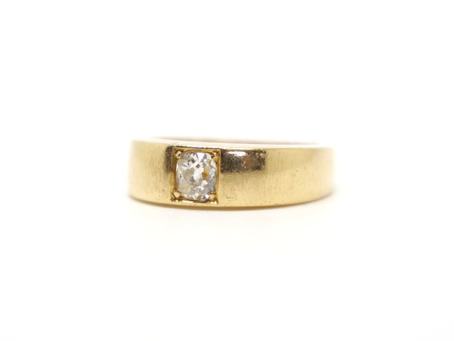 An 18ct gold Victorian gold gypsy ring dating from 1879 featuring a single old mine cut diamond of approximately 0.4 carats.