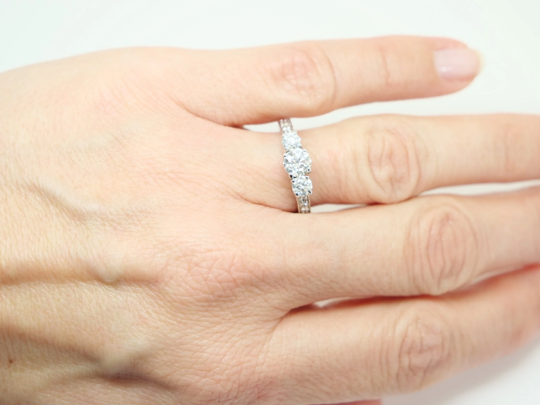 Very pretty 14ct gold diamond three stone ring, with a large central diamond of approximately 0.56ct, with a diamond to each side.