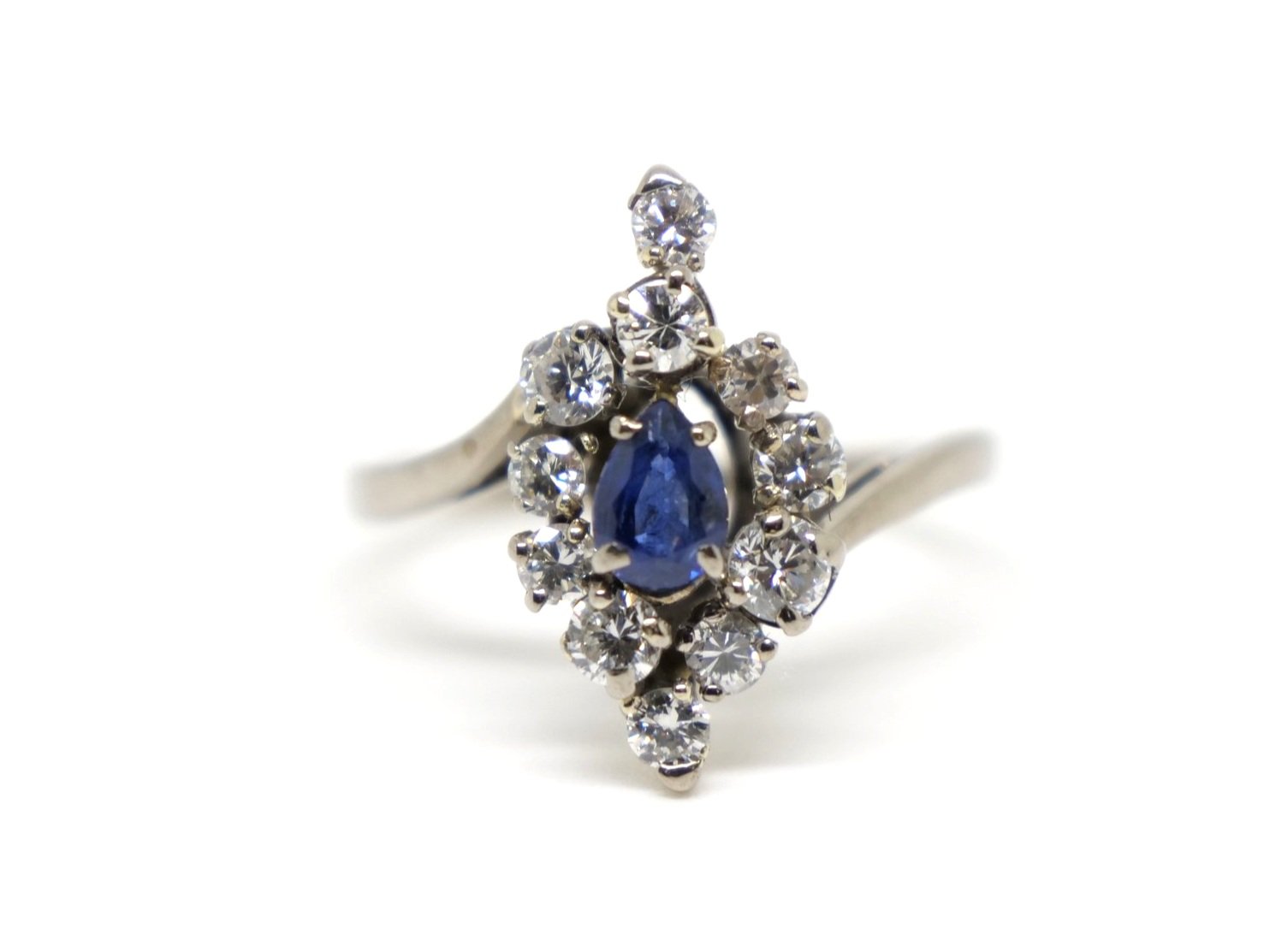 Unusual vintage 18ct gold sapphire and diamond cocktail ring, set with a central pear cut sapphire and surrounded by brilliant cut diamonds of different sizes.
