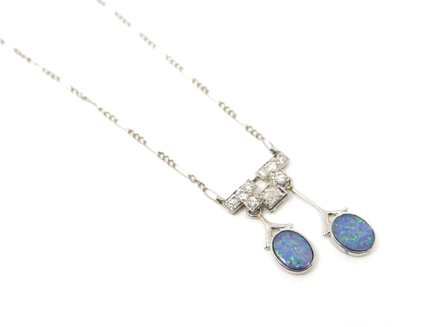 Stunning Art Deco platinum necklace, set with two drop opals and a geometric design set with old cut diamonds.