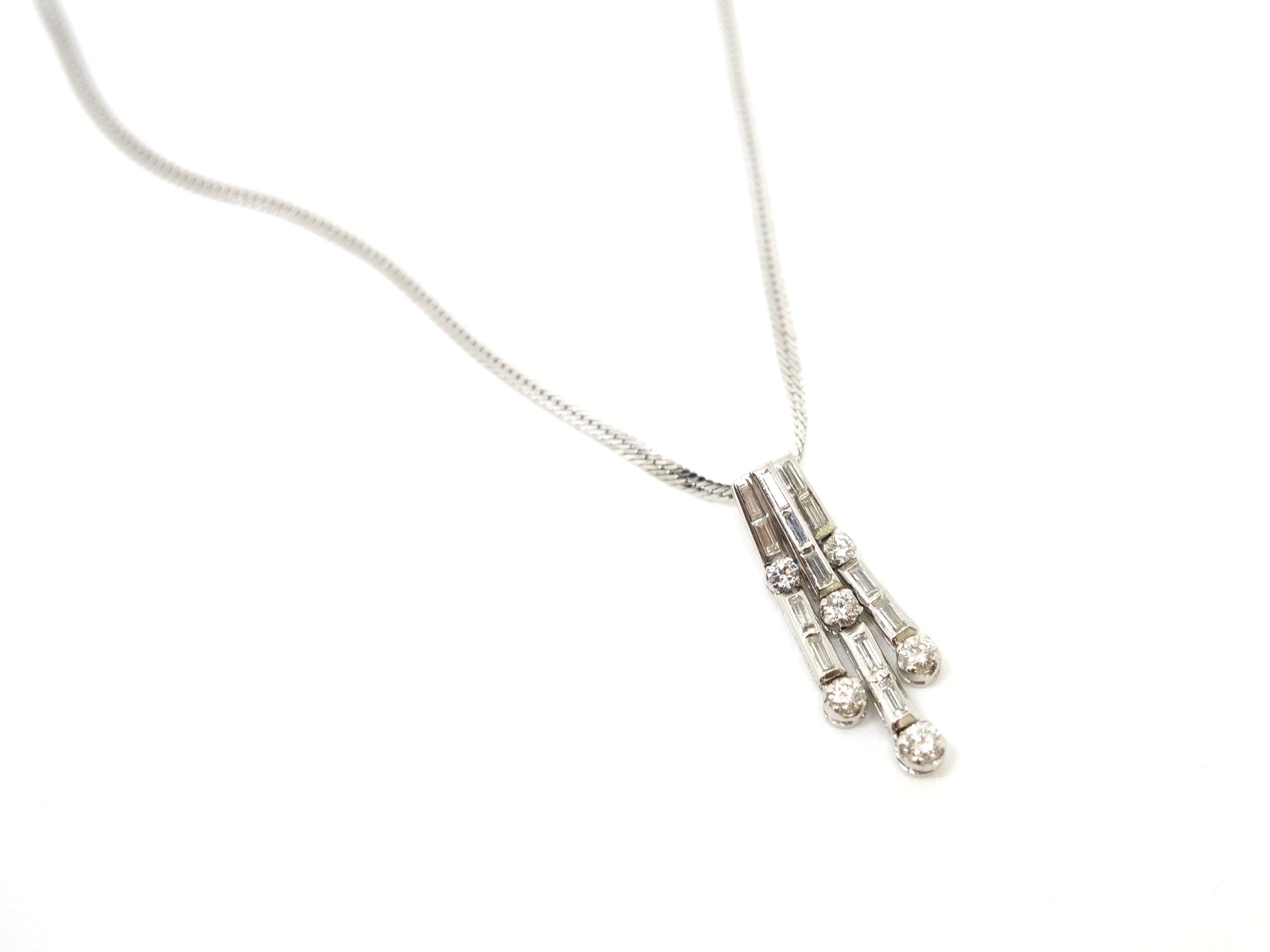 Superb platinum diamond waterfall design pendant, set with a mixture of brilliant and baguette cut diamonds. With platinum chain.