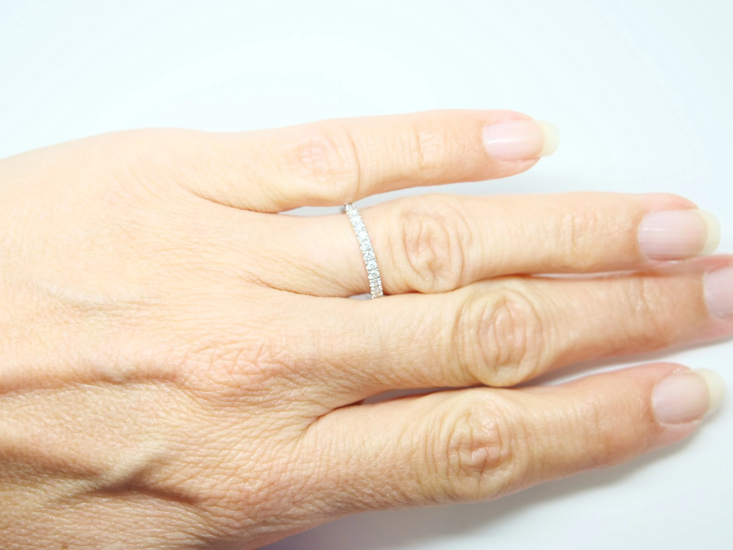 platinum diamond two thirds eternity ring set with round brilliant-cut diamonds pavé-set around the band