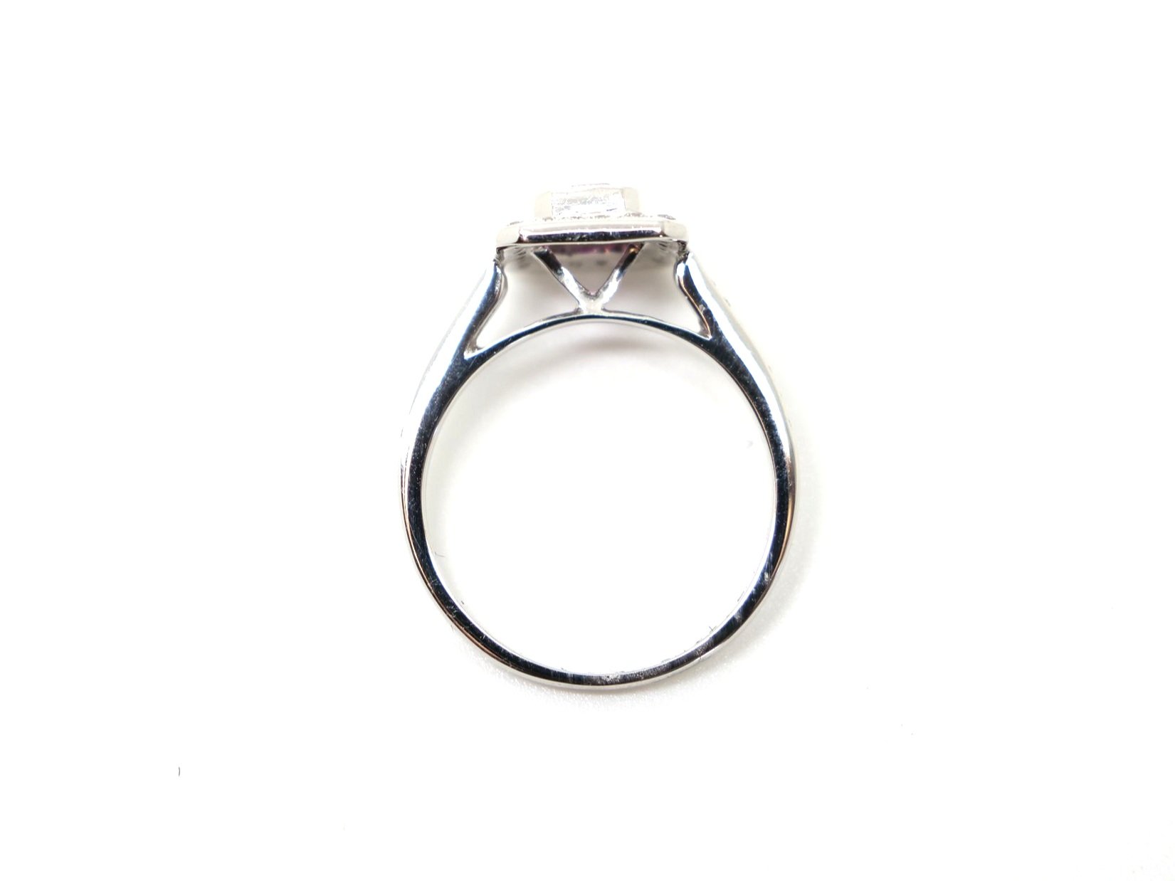 Lovely 18ct gold pink sapphire and diamond ring, set with a centre emerald cut pink sapphire of approximately 1.15cts, surrounded by diamonds. Further diamonds to each shoulder.