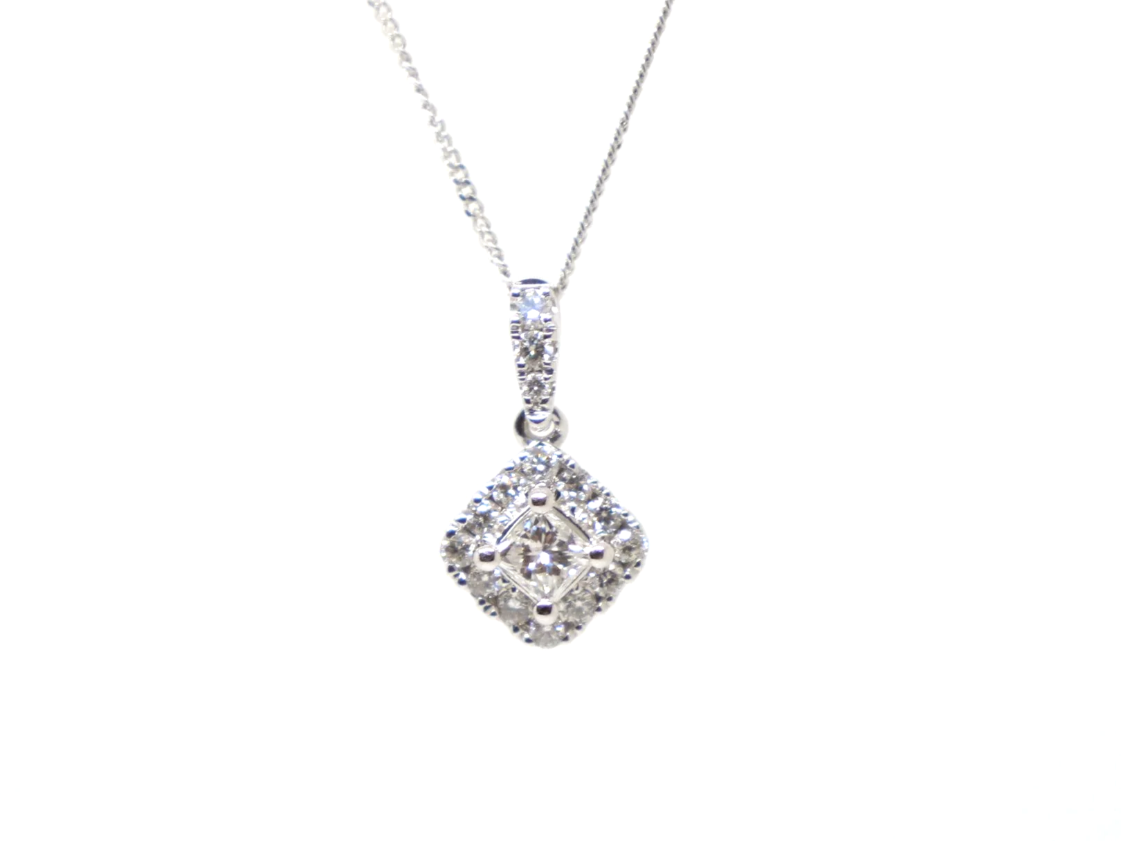 Very pretty 9ct white gold pendant set with a central princess cut diamond, framed by a cluster of brilliant cut diamonds to form a soft diamond shape.