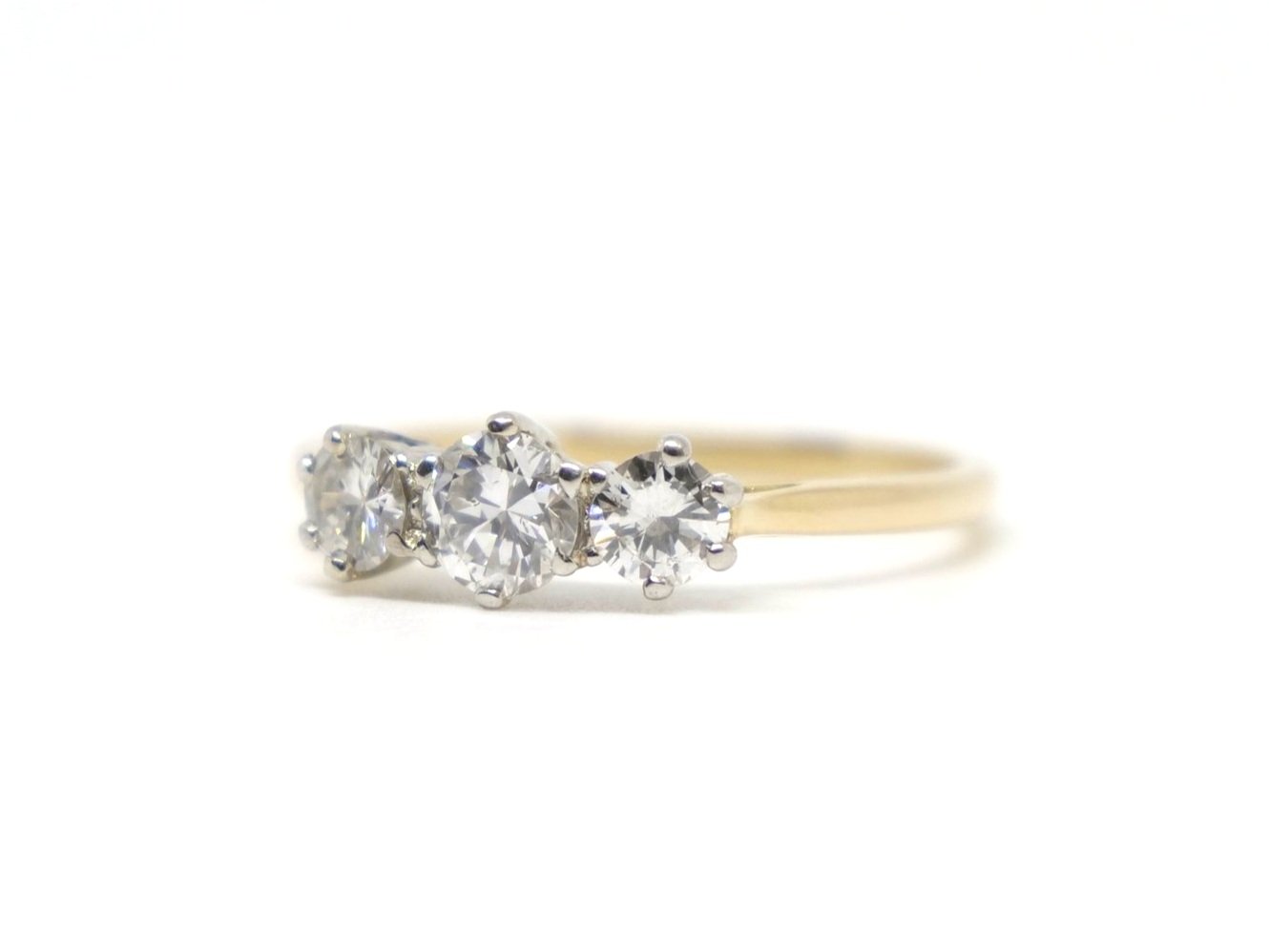 Lovely vintage diamond trilogy ring, set with three slightly graduated diamonds in 18ct gold. Central diamond approximately 0.44cts, with each side diamond approximately 0.25cts.