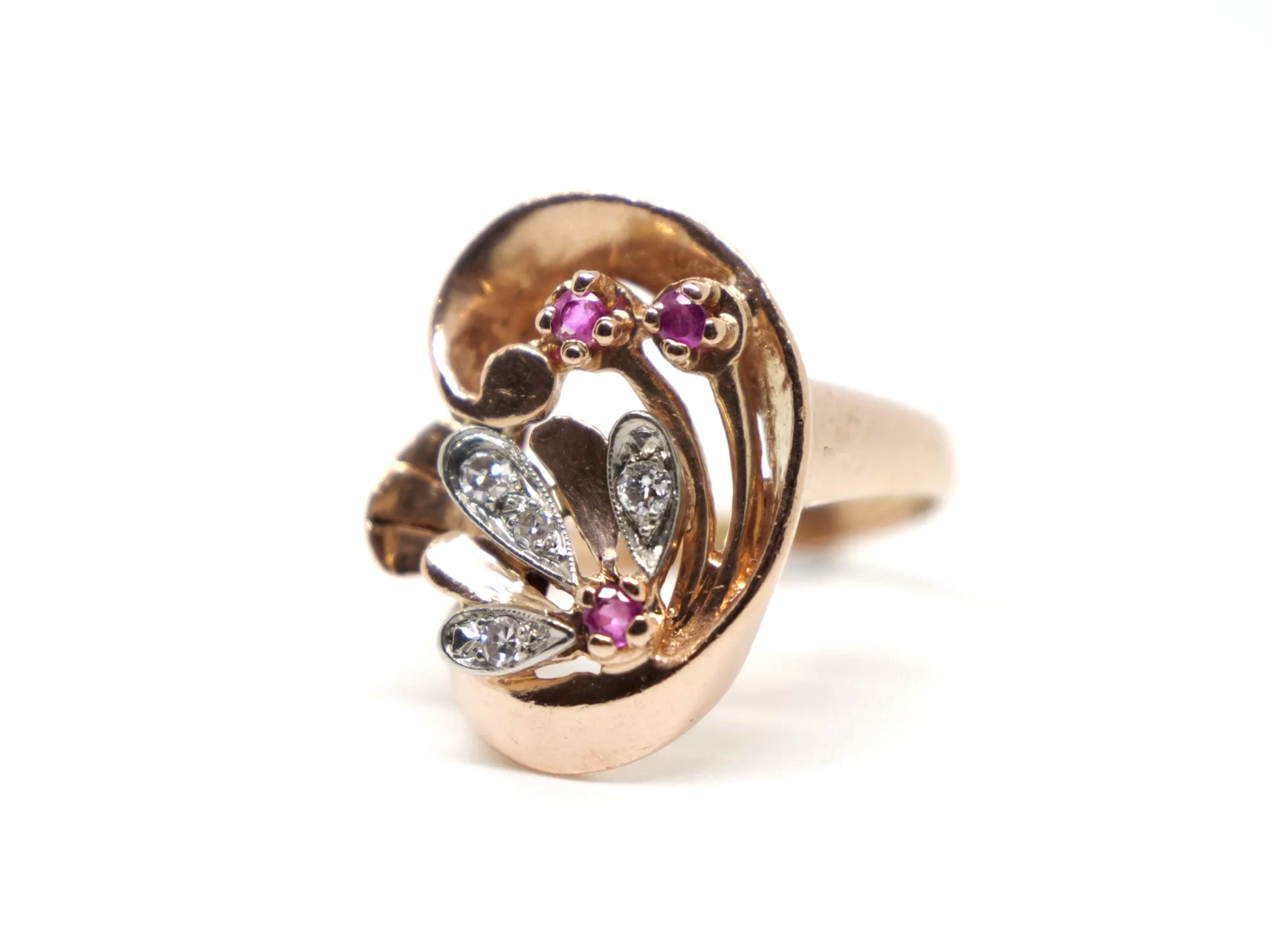 Very unusual 14ct rose gold Art Deco ring, in a large swirl style design. Each of the flower elements of the ring are set with round cut rubies, with diamonds set into each petal.