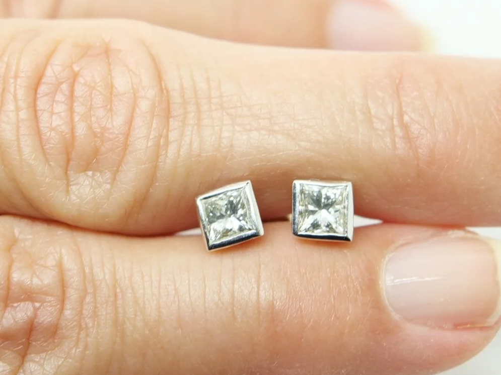Very pretty 18ct gold princess cut diamond stud earrings in a lovely rubover setting. Each princess cut diamond is approximately 0.39ct, with a total combined weight of approximately 0.78ct.