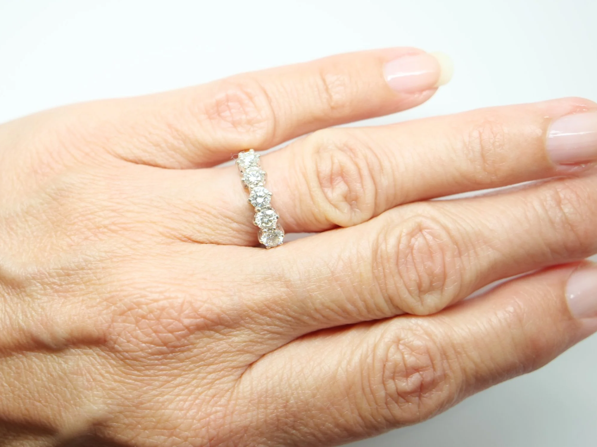 A classic five stone diamond ring in 18ct gold, set with five round brilliant cut diamonds of 1 carat in total.