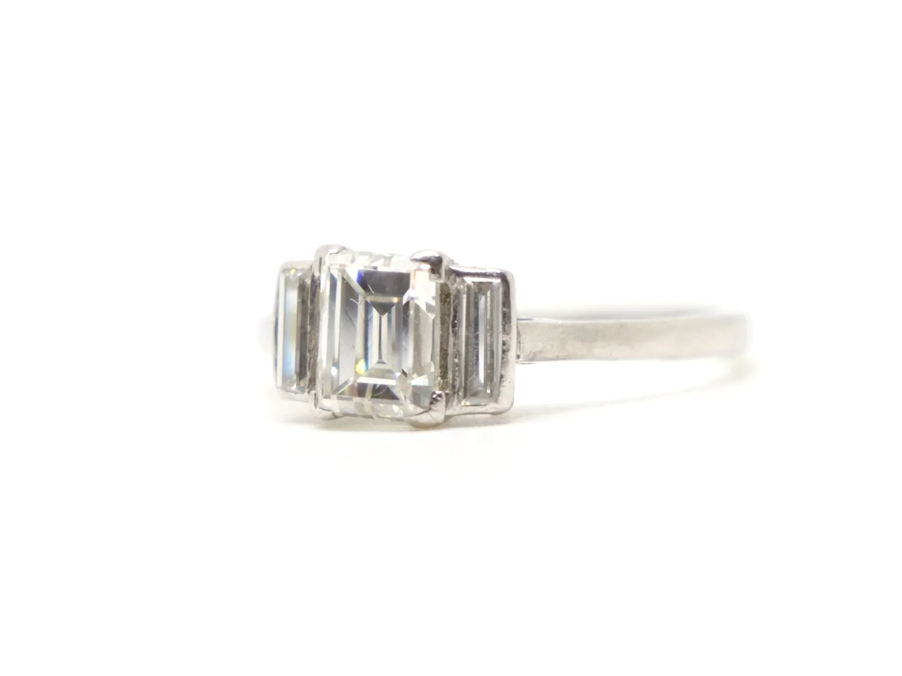 Very unusual vintage platinum diamond ring, set with a lovely baguette cut diamond of approximately 0.95ct. Two further baguette cut diamonds.