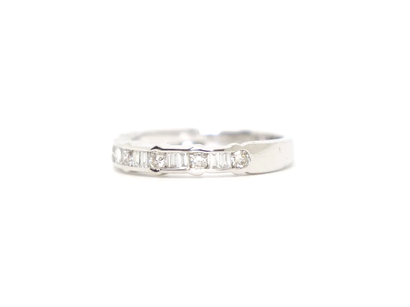 18ct white gold half eternity ring with alternating round and baguette cut diamonds