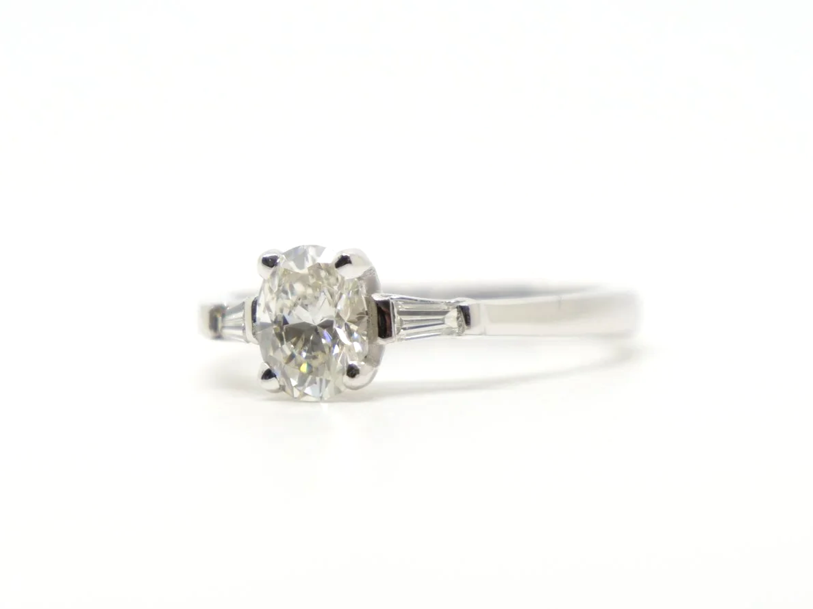 Gorgeous 18ct gold oval cut diamond solitaire ring, with an approximately 0.65ct oval cut diamond and with a tapered baguette to each shoulder.