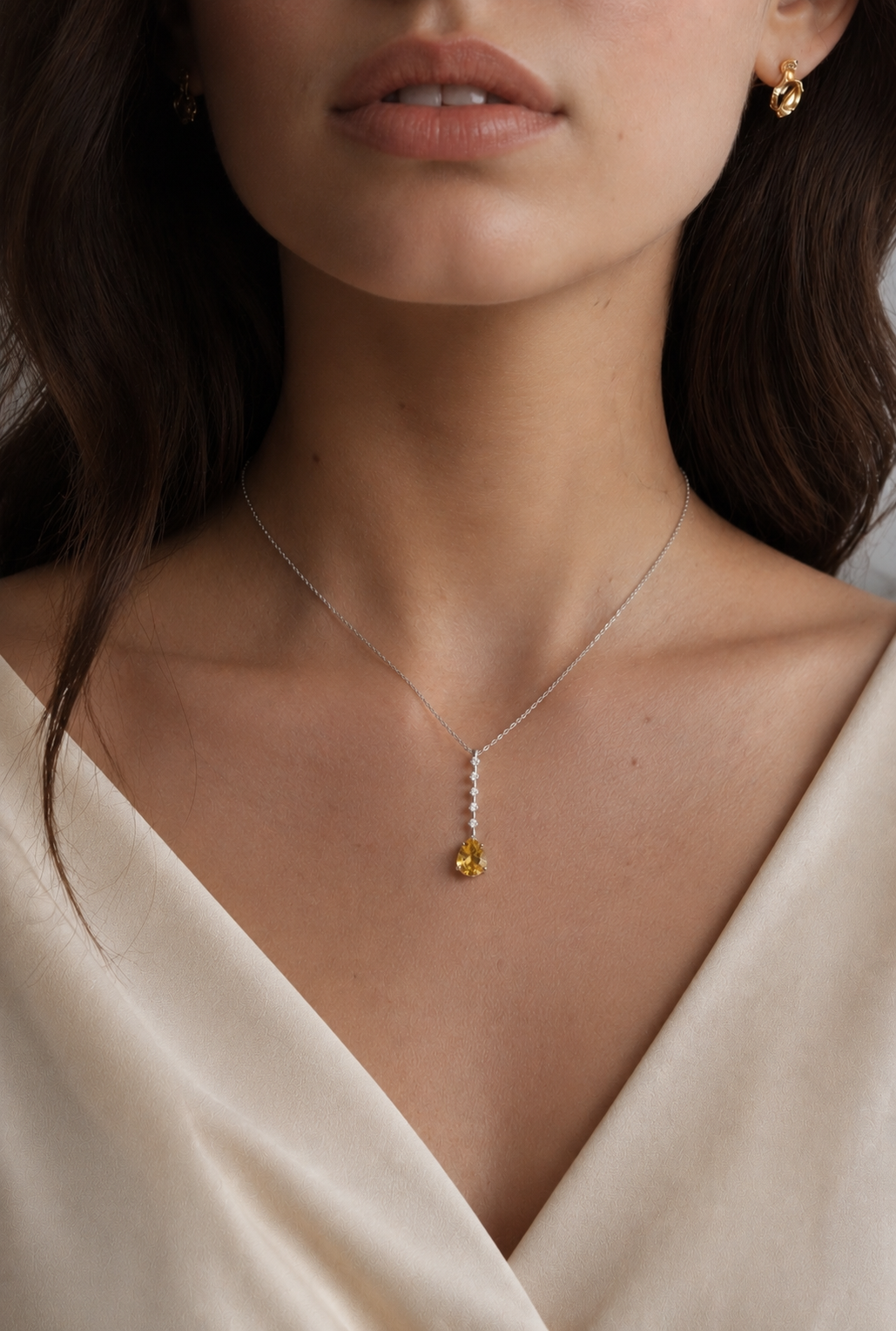 A 9ct white gold citrine and diamond pendant