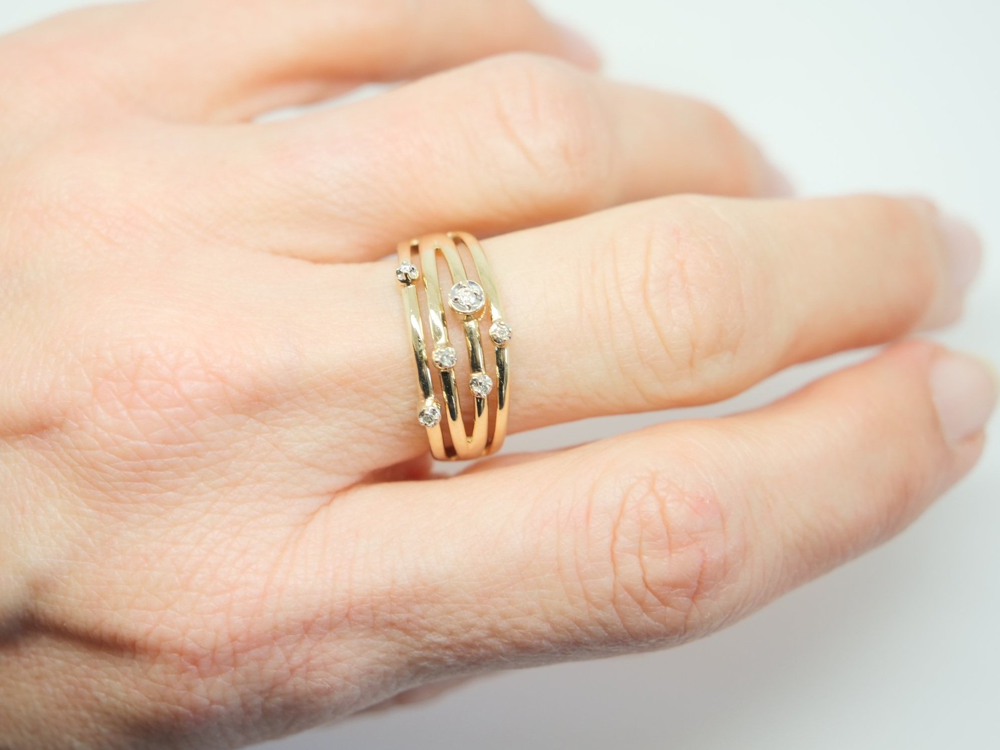 Contemporary designer style 9ct gold bubble style ring, with a four band design and set with six diamonds.