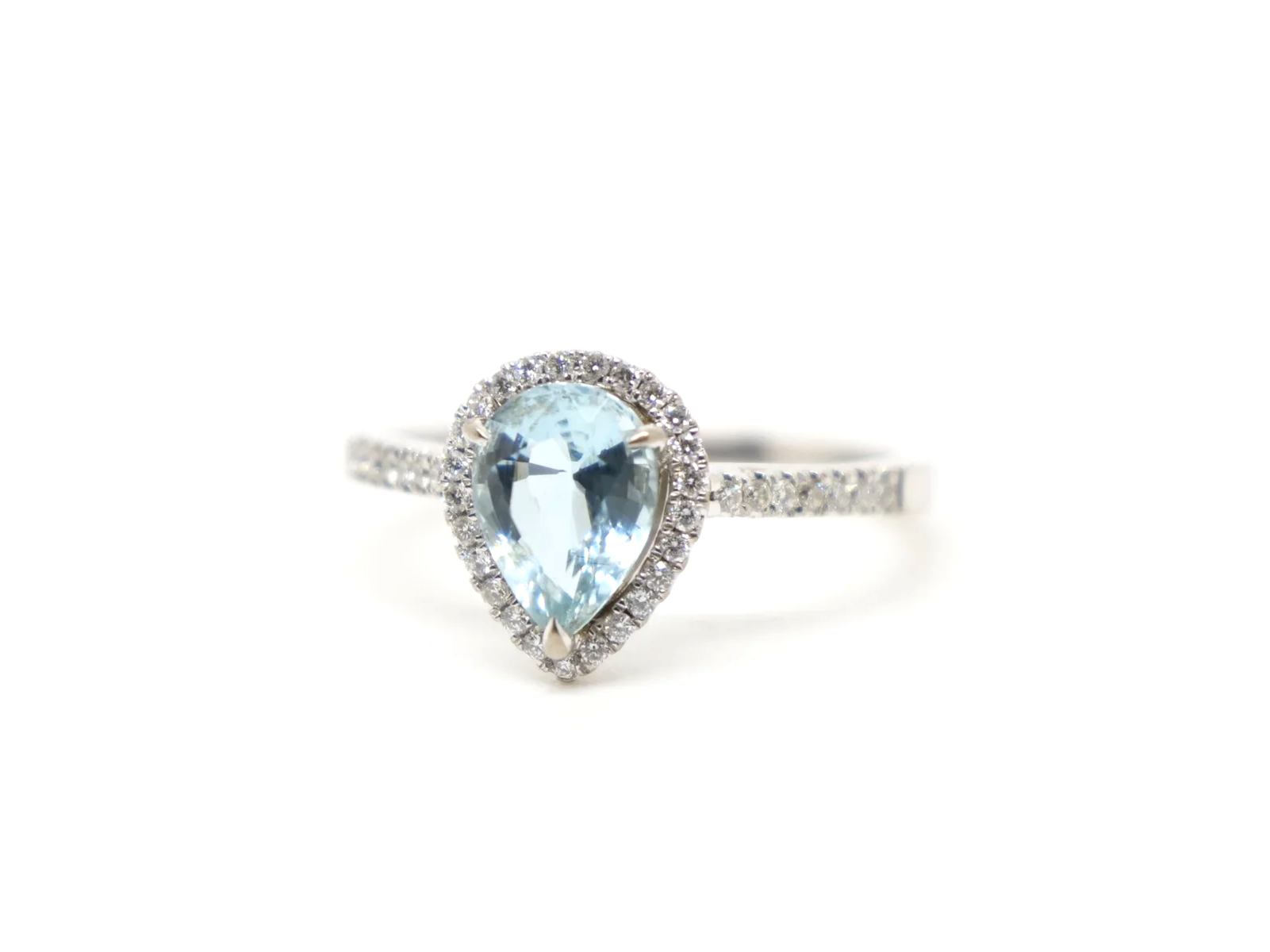 18ct white gold aquamarine and diamond halo ring, set with a pear cut aquamarine at the centre