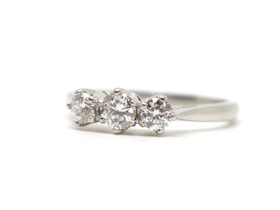 Super platinum diamond three stone ring, set with three brilliant cut diamonds graduating from centre stone. Approximately 0.86ct total diamonds.