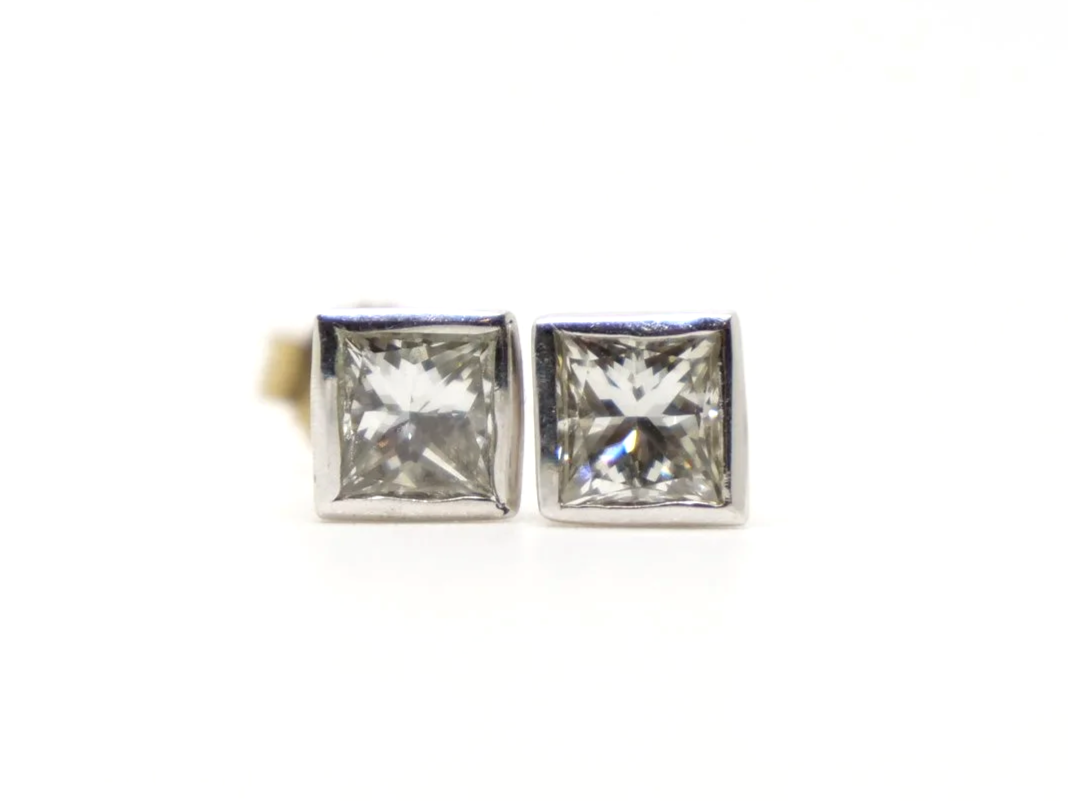 Very pretty 18ct gold princess cut diamond stud earrings in a lovely rubover setting. Each princess cut diamond is approximately 0.39ct, with a total combined weight of approximately 0.78ct.