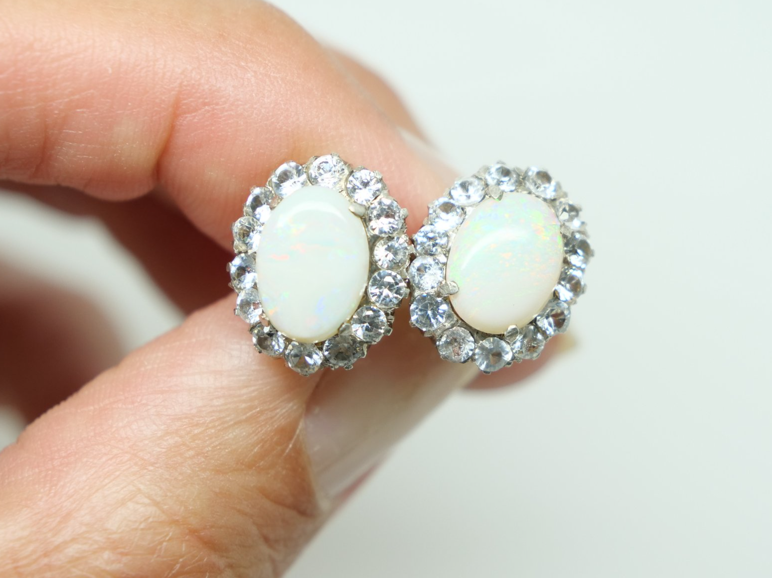 Beautiful 1930’s 9ct gold opal and white sapphire earrings, set with a large opal and surrounded by white sapphires.