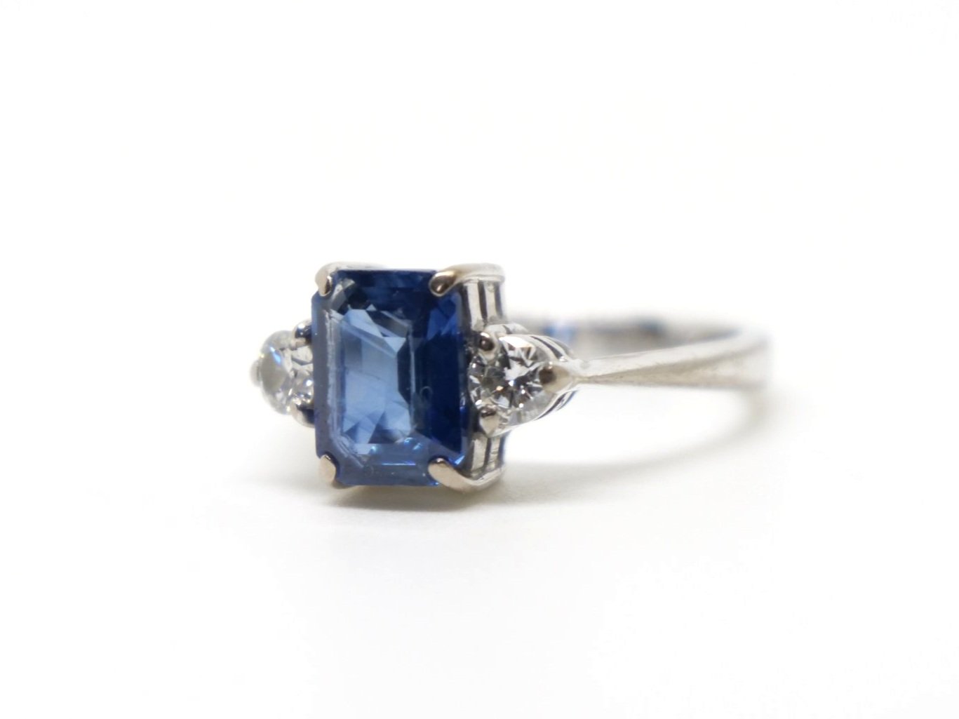 Lovely vintage 18ct gold sapphire and diamond three stone ring, set with a centre emerald cut sapphire of approximately 1.75cts, with a brilliant cut diamond to each side.