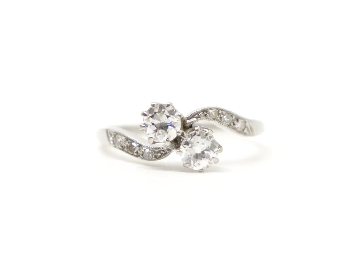 Super platinum diamond toi et moi ring, set with two old cut diamonds, with further diamonds set into each shoulder.