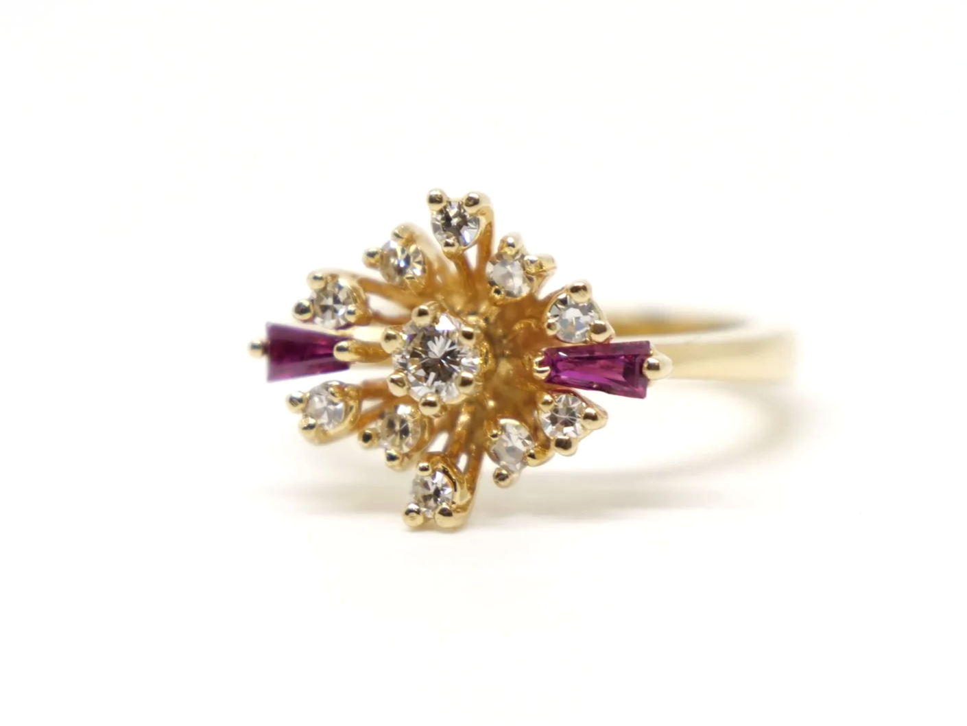 Unusual vintage 14ct gold ruby and diamond spray design ring, with a diamond centre and further diamonds in this east west marquise design. Highlighted with two tapered baguette cut rubies.