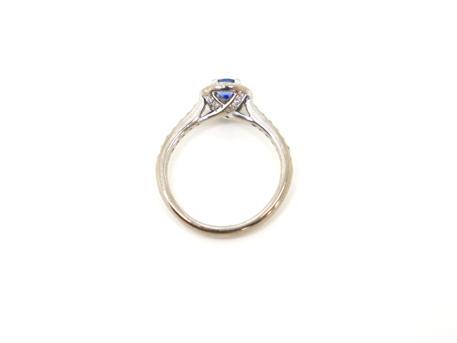 Lovely sapphire and diamond halo ring in 18ct white gold, set with a round-cut blue sapphire of approximately 0.35ct, and encircled by a halo of brilliant-cut diamonds