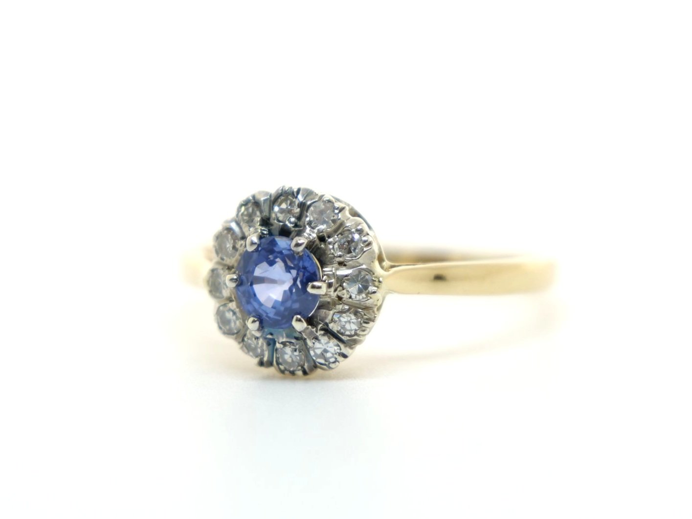 Pretty vintage 18ct gold sapphire and diamond ring in flower design, set with a round cut light blue sapphire and small diamonds.