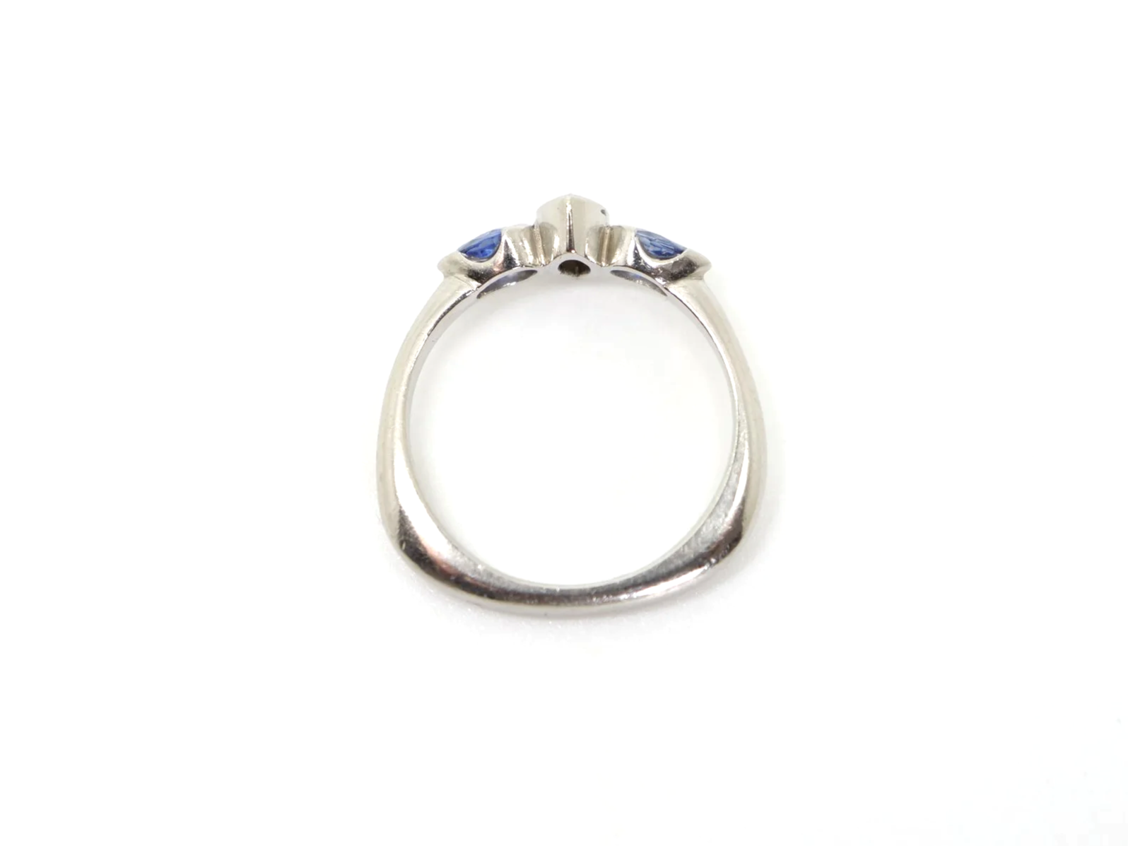 Beautiful platinum diamond and sapphire three stone ring, set with a marquise cut diamond and two pear cut sapphires.