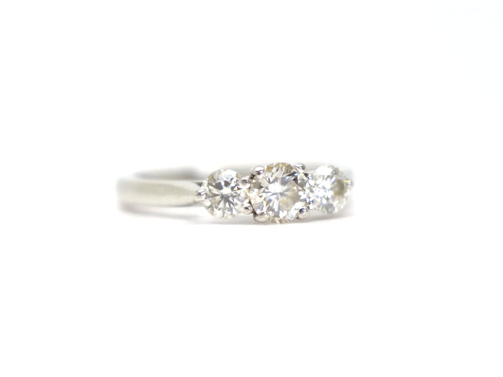 Platinum three stone diamond ring, three round brilliant cut diamonds in claw settings, hallmarked 2010, UK size L