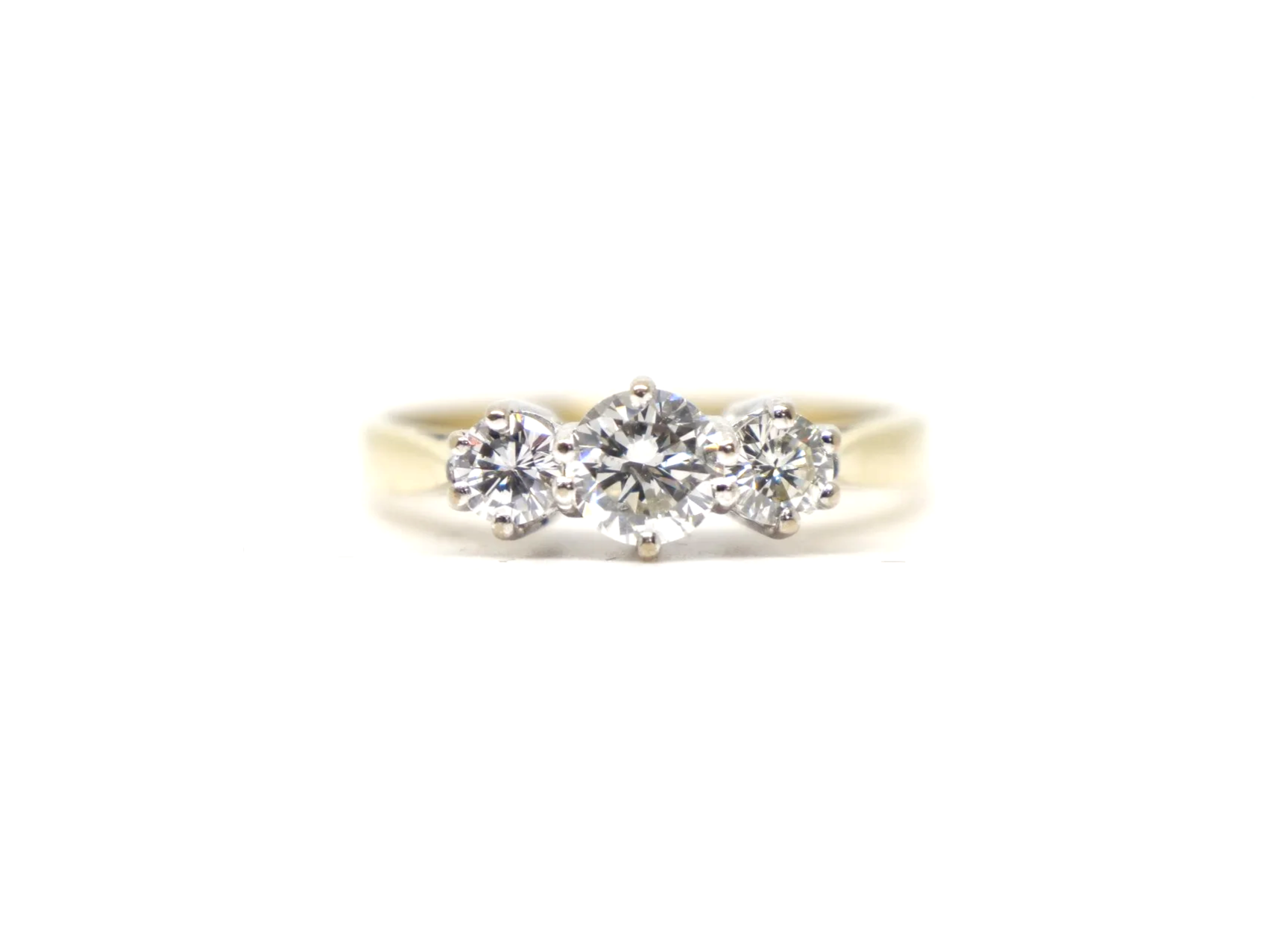 A classic 18ct gold diamond three stone ring from 1997, set with three round brilliant cut diamonds of approximately 1 carat in total.