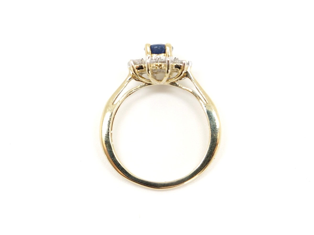 Lovely sapphire and diamond cluster ring, set with a 1ct oval cut mid blue sapphire and surrounded by 0.5ct brilliant cut diamonds.