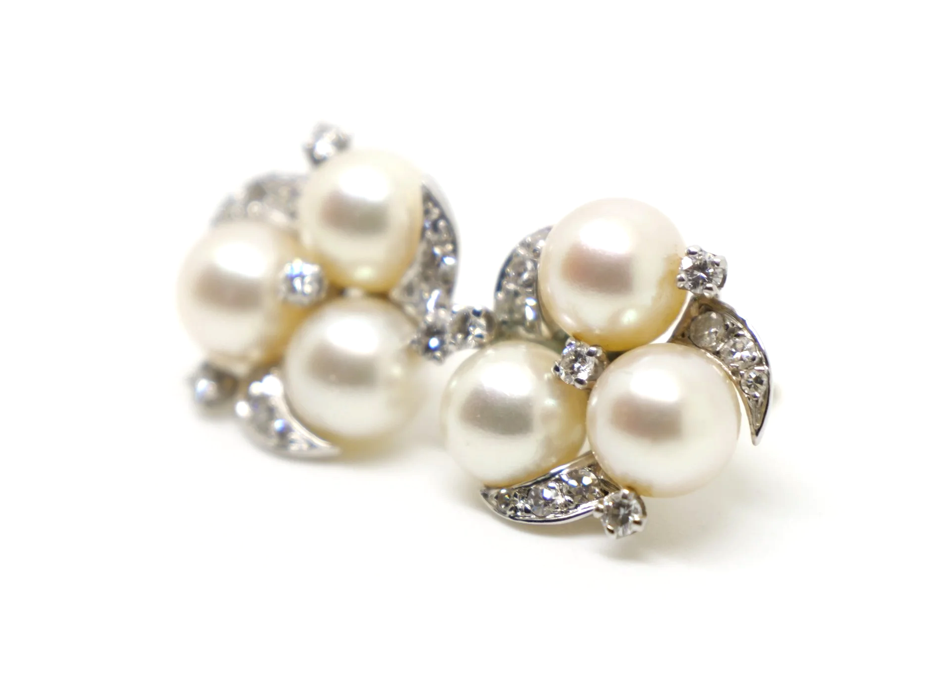 Lovely vintage pearl and diamond earrings in 14ct gold, each set with three pearls with diamonds in a lovely floral design.