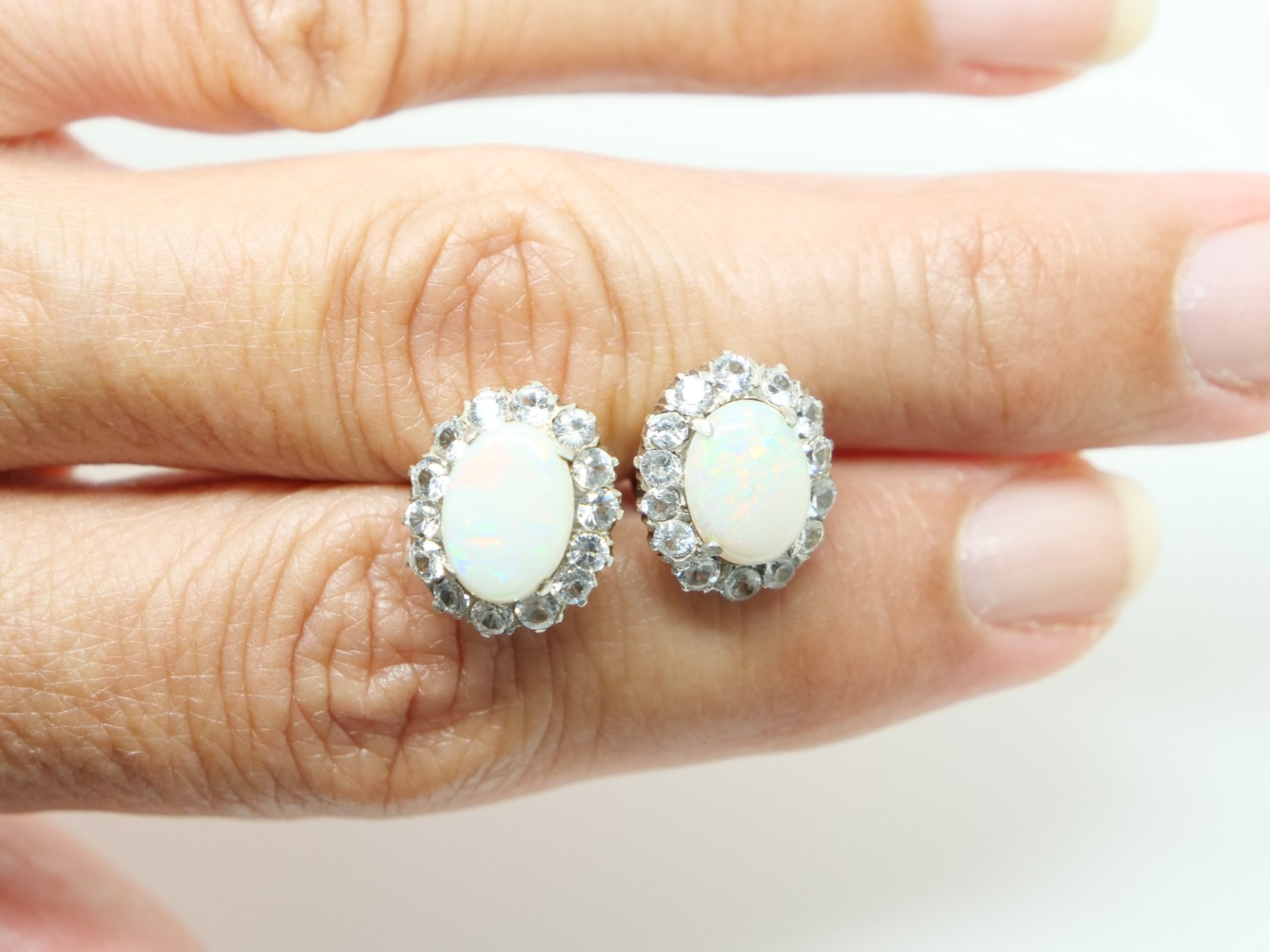 Beautiful 1930’s 9ct gold opal and white sapphire earrings, set with a large opal and surrounded by white sapphires.