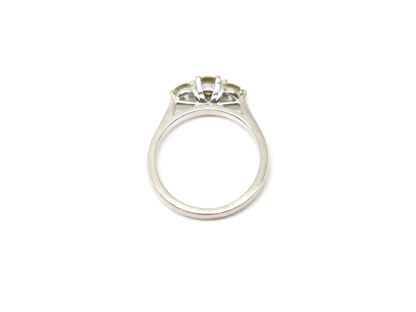 Platinum three stone diamond ring, three round brilliant cut diamonds in claw settings, hallmarked 2010, UK size L