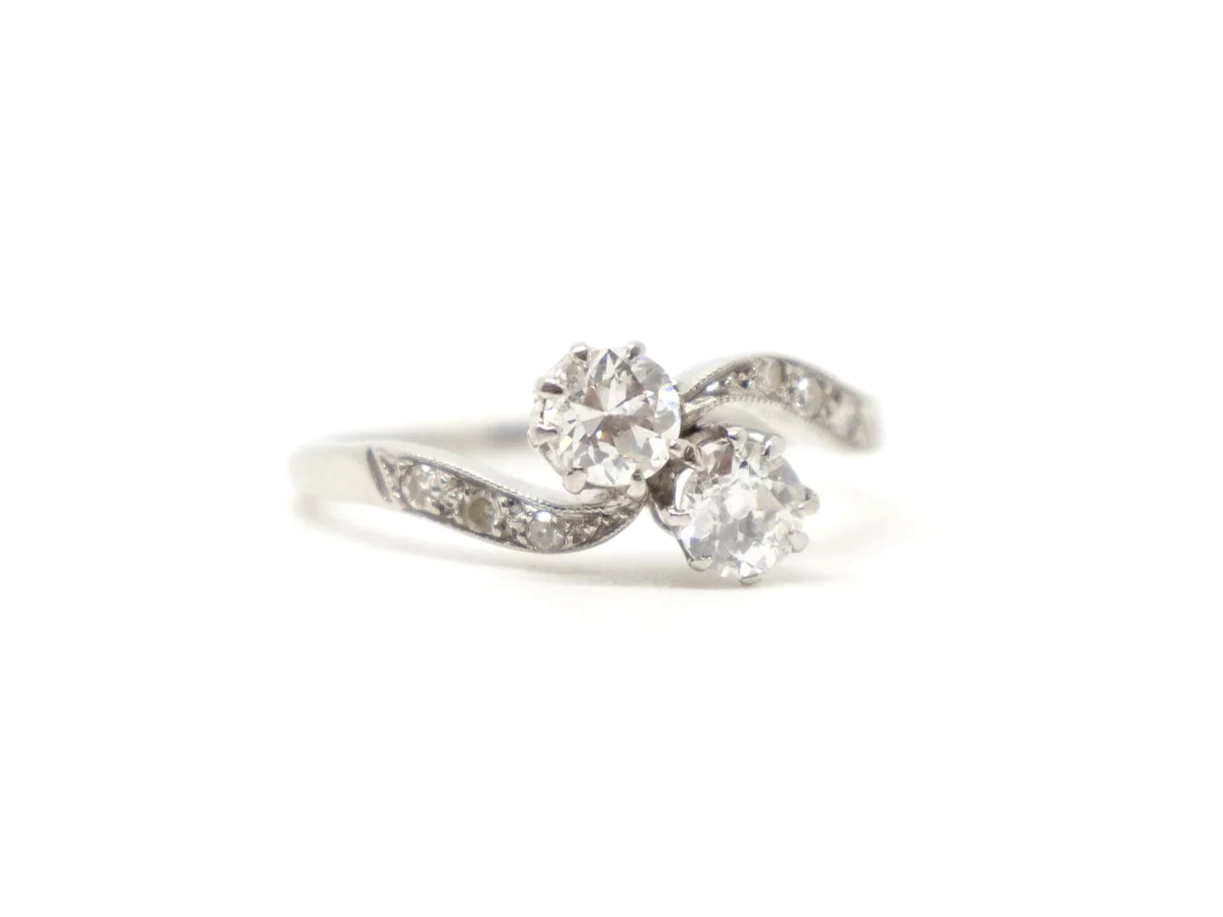 Super platinum diamond toi et moi ring, set with two old cut diamonds, with further diamonds set into each shoulder.