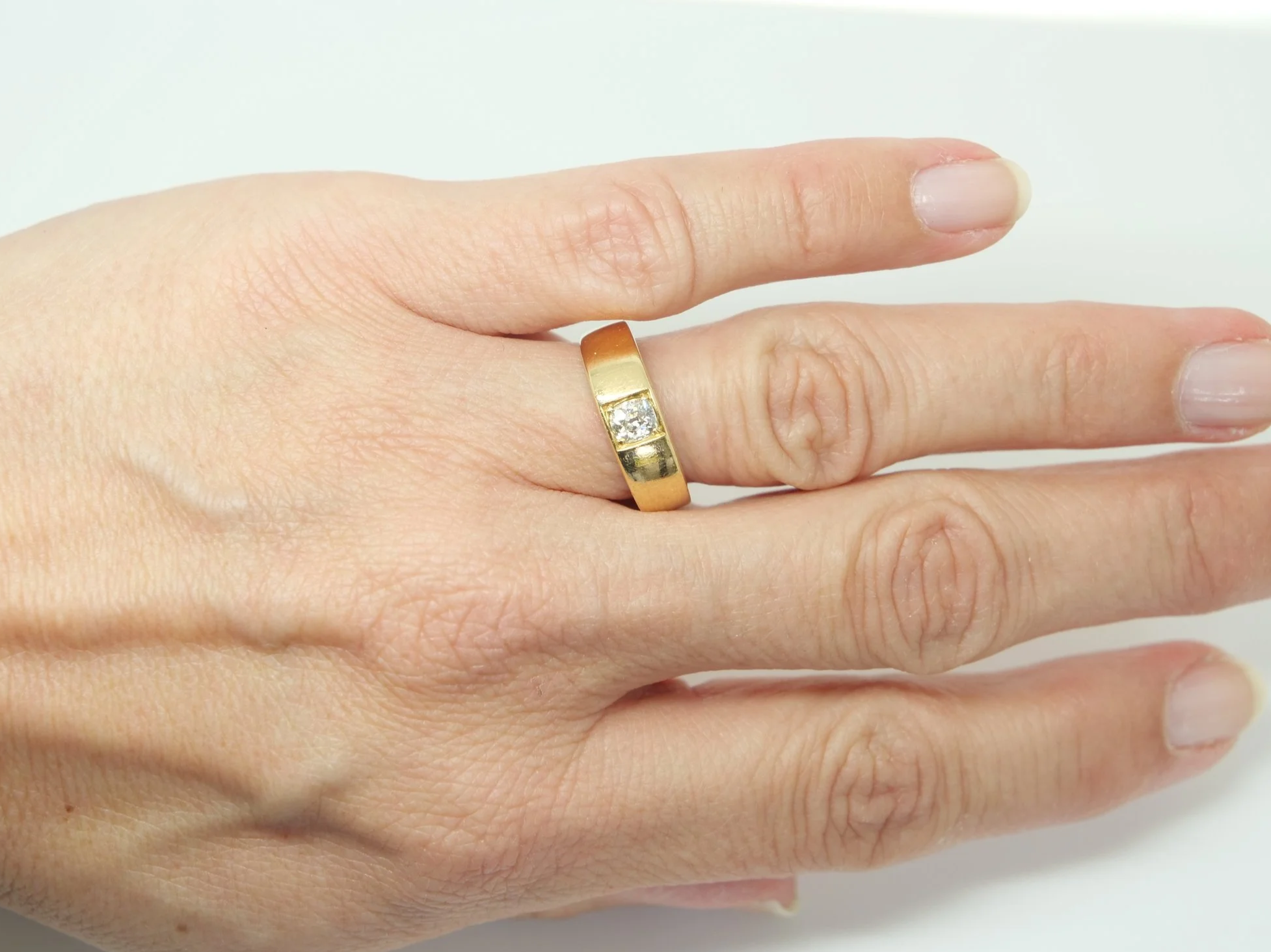 An 18ct gold Victorian gold gypsy ring dating from 1879 featuring a single old mine cut diamond of approximately 0.4 carats.