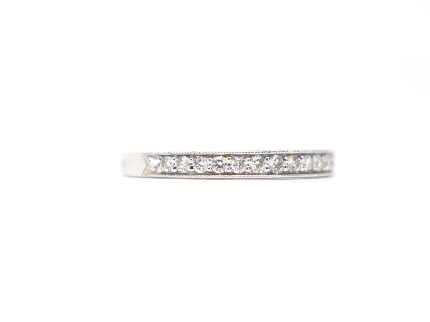 pretty platinum diamond half-eternity ring set with round brilliant-cut diamonds